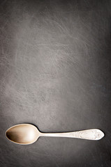 Vintage metal spoon on dark background