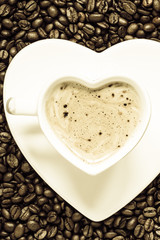 white coffee cup heart shaped with cappucino