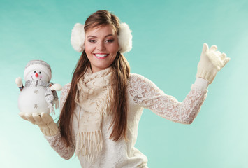 Smiling cute woman with little snowman. Winter.