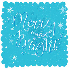 Merry and bright. Christmas lettering at blue snow background, holiday card with calligraphy