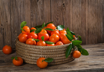 Big basket with freshly plucked tangerines