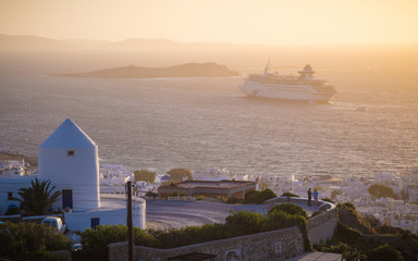 Sunset at Mykonos with windmills and cruise ship, Greece