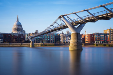 St Paul's Cathedral and Millennium Bridge in sunset, London, UK