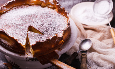 Plum cake in the shape  with powdered sugar.selective focus