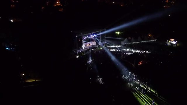 AERIAL: Crowd of people dancing on a music festival