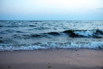Sea wave on the shore at sunset