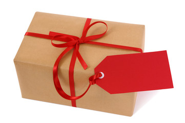 Brown paper package parcel or present one single small tied with red ribbon and gift tag for christmas birthday or valentine isolated on white background photo