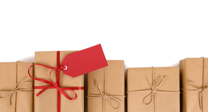 Border Of Brown Paper Parcels, One Unique With Red Ribbon Bow And Gift Tag