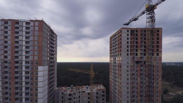 Construction site with workers and tower cranes