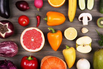 Different fruits and vegetables on wooden background
