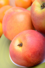 many different fruits for the health of the entire family, peach, mandarin, apple
