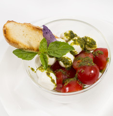 tomatoes and cheese on white plate in a restaurant