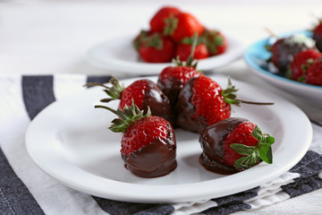 Served table with delicious strawberries in chocolate