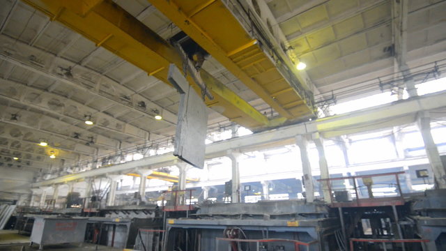 Bridge crane rides on factory floor