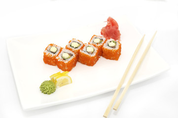 plate of sushi beautifully decorated with salad and fruit on a white background