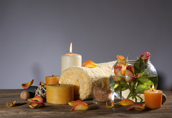 Beautiful spa composition with alight candles on wooden table