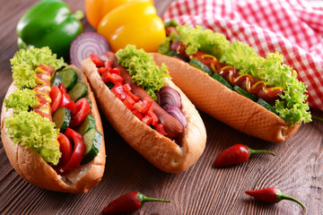 Hot dogs on wooden background closeup
