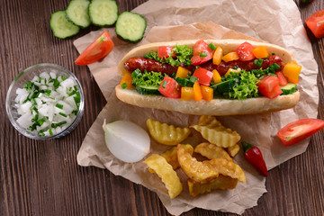 Hot dogs and vegetables on craft paper closeup