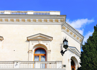 Fototapeta na wymiar White building with balcony and stone staircase