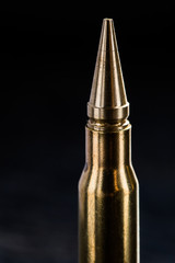 Top of the rifle cartridge on a dark background