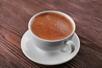 Cup of coffee on wooden background