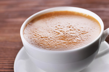 Cup of coffee on wooden background