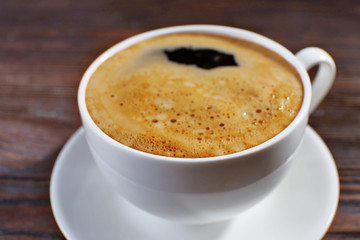 Cup of coffee on wooden background