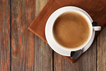 Cup of coffee on brown napkin closeup
