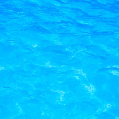 Blue pool water with sun reflections