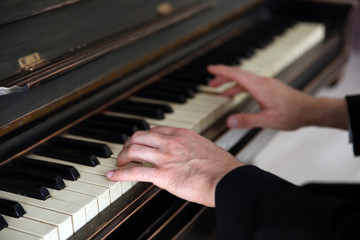 Fototapeta na wymiar Close up of man hands classic piano playing