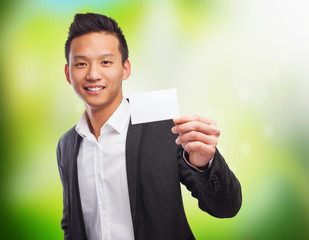 portrait of an asian man holding a white card