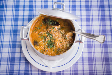 Rice with fish / in the picture we can see a delicious pot of rice with seafood