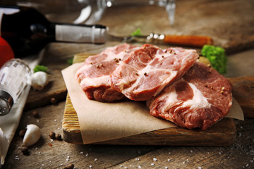 Marbled beef steak and spices on wooden background
