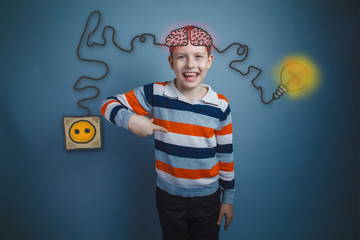 Boy shows his index finger down and laughs charging cord plug wi