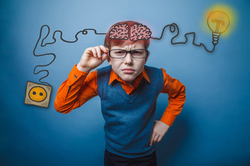 boy with glasses and an orange shirt, leaned forward charging co