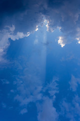 sun beam in blue sky with clouds background