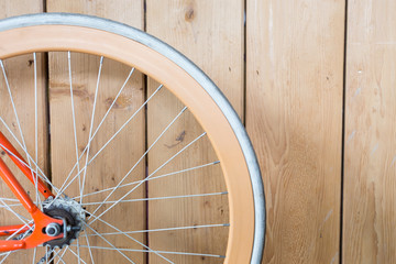 bicycle parked with wood wall, close up image part of bicycle