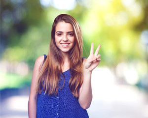 young cute woman doing a victory gesture