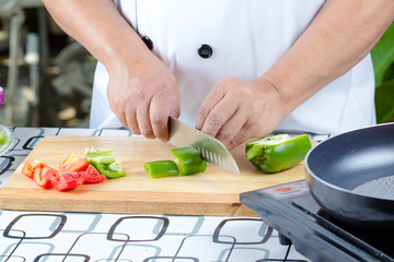 Chef cutting tomato
