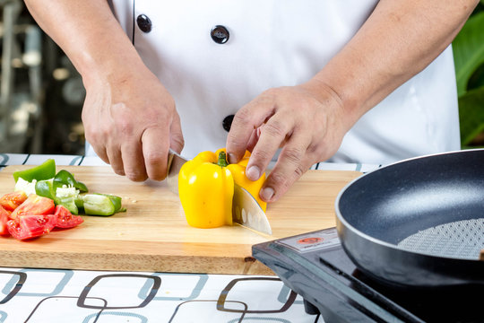 Chef cutting tomato