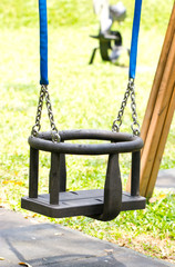 Close up of swing in a children play area at park.