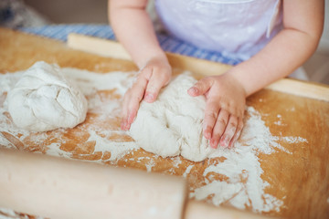Obraz na płótnie Canvas A child human hands sculpts a dough