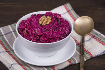 Fresh salad with beet and walnuts on white plate