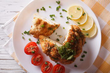 baked cauliflower and fresh tomatoes close-up. Horizontal top view
