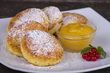 Delicious homemade cheese pancakes with honey  in white plate