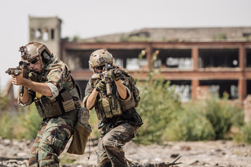Fototapeta premium Private Military Contractor on patrol in destroyed city