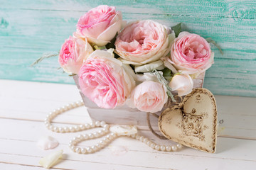Sweet pink roses in box and decorative heart