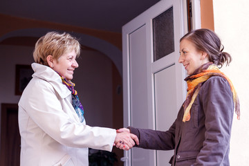 Women greeting girl