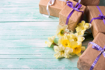 Bunch of yellow daffodils  flowers and wrapped gift boxes