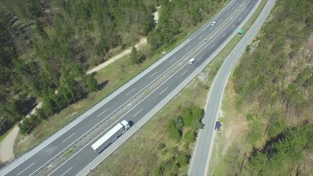 AERIAL: Trucks and cars driving on a freeway